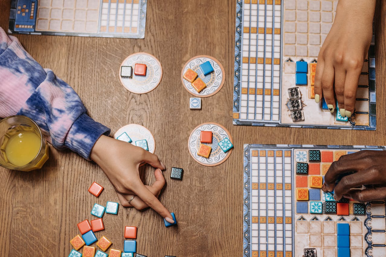 people playing a European-Style Tabletop game on a wooden table