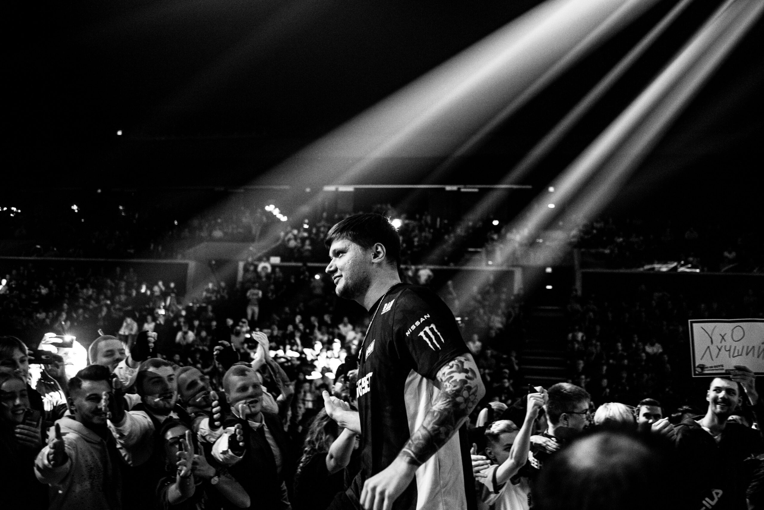 s1mple walking in front of a large crowd of CS2 fans