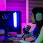 a woman playing Blue Prince on her PC while talking to her friends on a mic