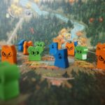 Components from Root, the board game, on a map of the game