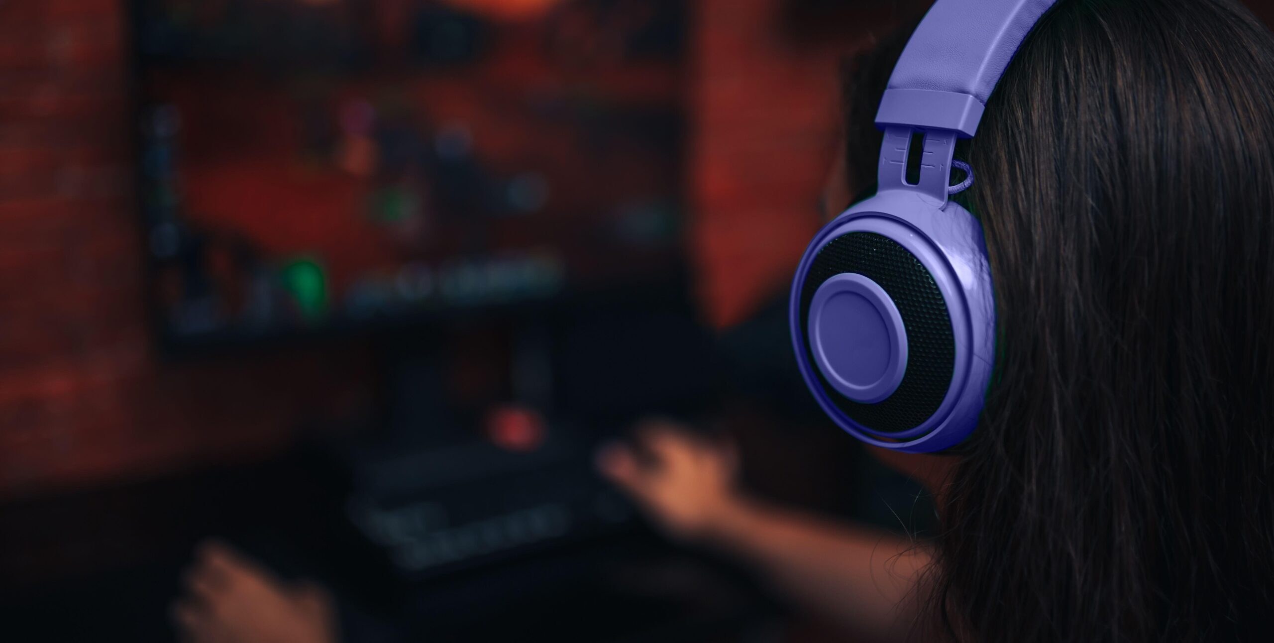 Girl in purple headphones Playing Endless Legend 2 on Her PC